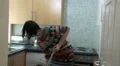 Female in kitchen cleaning in a panic HD Footage