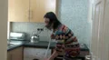 Female in kitchen talking on phone HD Footage