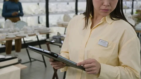 Female Kitchenware Store Manager Ordering New Stock on Tablet Stock Footage 321775243