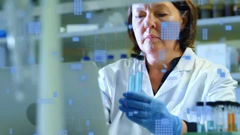 Female lab tech grabbing pipet prepping and checking tubes to test while overlay Stock Footage 335234972