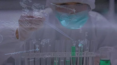 Female lab tech pressing pipette, adding green solution into test tubes for Stock Footage 329575786