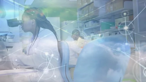 Female lab tech using scope and adjusting samples while cloud overlay linking Stock Footage 330380351
