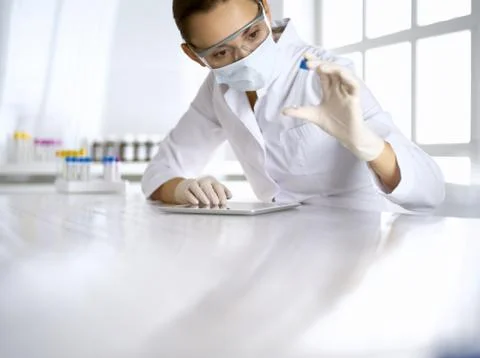 Female laboratory assistant analyzing a blood sample at hospital. Medicine Stock Photos