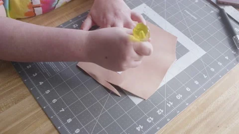 Female leather worker tracing pattern onto leather with an awl. Stock Footage 171814694