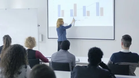 Female lecturer explaining the chart carefully in a classroom Stock Footage 69933333