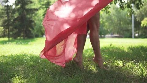 Female legs closeup. the girl in the red dress and shoes on high heels is Stock Footage