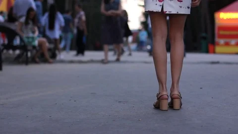 Female legs dancing salsa. People dancing in the evening city park. Stock Footage 77447235