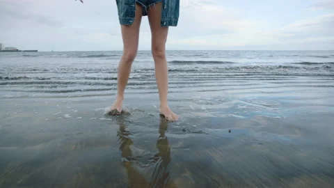 Female legs dancing on a sandy beach. Stock Footage 237482633