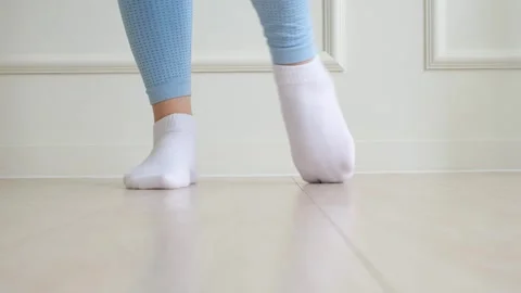 Female legs doing exercises and stretching feet on white background front view. Stock Footage 282147960