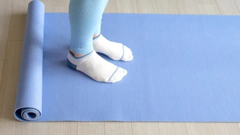 Female legs doing exercises lifting on toes close-up on blue background. Stock Footage 240169504