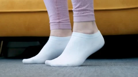 Female legs doing exercises lifting on toes close-up, home workout concept. Stock Footage 302882366