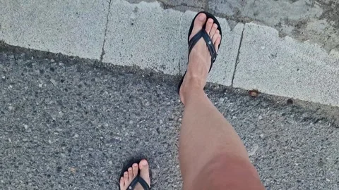 Female legs in flip flops walking down the street, first person view Stock-Footage 295889190