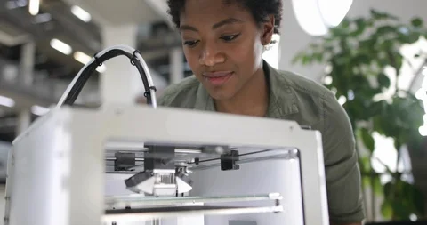 Female looking at 3D printer Stock Footage 86819268