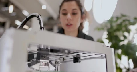 Female looking at 3D printer Stock Footage 86819622