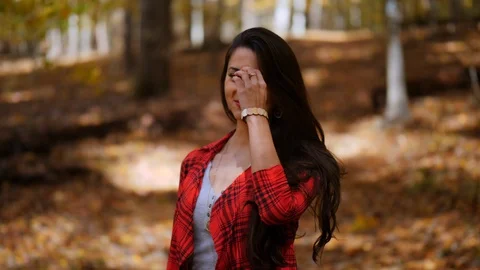 Female looking directly at the camera. Fall season in the forest Video stock 103435034