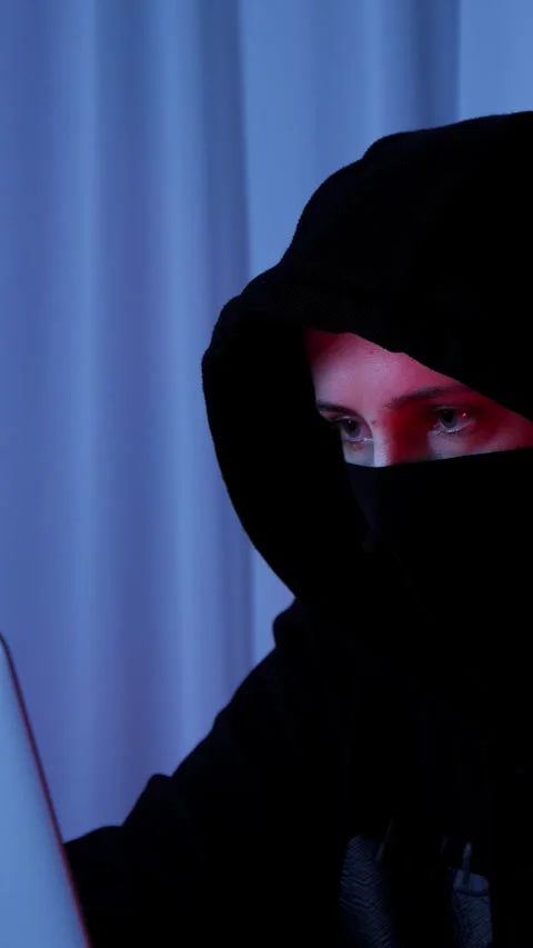 Female looking at laptop screen, typing on keyboard in dark room. Vertical video Stock Footage 318162632