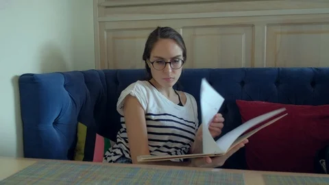 Female looking at menu in restaurant Stock-Footage 87840644