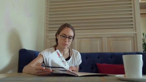 Female looking at menu in restaurant Stock Footage 87840848