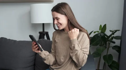 Female looking at smartphone screen, getting message with unbelievable good news Stock Footage 203182313
