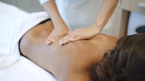 Female lying on back massage session in spa salon Stock Footage 111033045