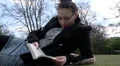 Female lying on side ready a book HD Footage