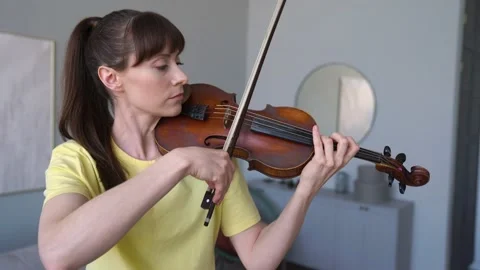 Female makes mistake while she is doing Exercises to Improve her Violin. Stock Footage 155111631
