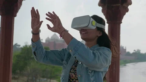 A female making hand gestures  while watching video in headset. Stock Footage 139917130