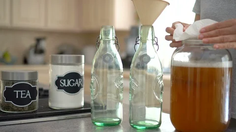 Female making kombucha tea in the kitchen Stock Footage 91950336