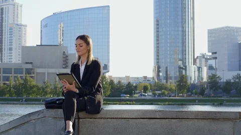 Female manager checking her email with tablet computer outdoors Stock Footage 120665995
