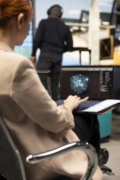 Female manager interacting with artificial intelligence in business lounge Stock Photos