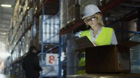 Female Manager of Logistics Warehouse is Working on Tablet PC. Stock Footage 54435321