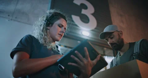 Female Manager Scanning Parcels with Barcode Scanner, Using Digital Tablet Stock Footage 313346092