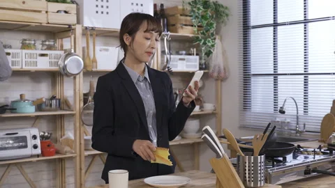 Female manager standing by the home kitchen Stock Footage 182858504