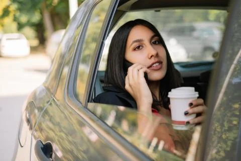 Female manager using mobile while sitting in car Stock Photos