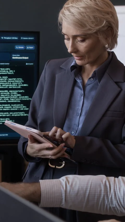 Female Manager Using Tablet Working with Colleague in Network Office Stock Footage 334928739