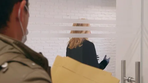 Female manager at work receiving files from a colleague during coronavirus ou 库存影片 128776633