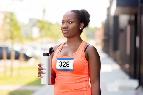 Female marathon runner drinking water from bottle Stock Photos