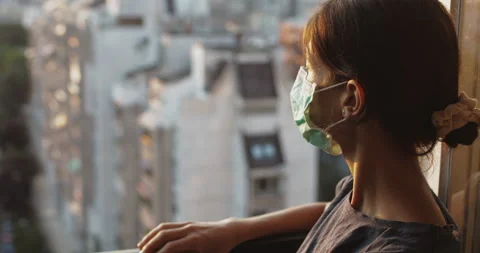 Female with mask looking through the windows. Stock Footage 137811849