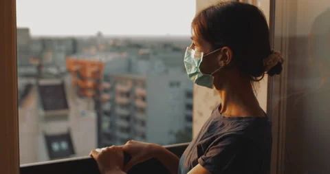 Female with mask looking through the windows. Stock Footage 137812787