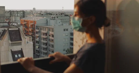 Female with mask looking through the windows. Stock Footage 137818533
