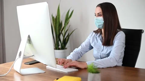 A female in mask using PC in the office Stock Footage 146463014