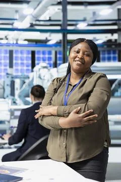 Female master engineer checks performance data in a solar panel factory Stock Photos