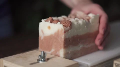 A female master soap maker cuts natural handmade soap Stock Footage 278301360