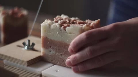 A female master soap maker cuts natural handmade soap Stock Footage 278301376