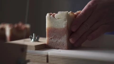 A female master soap maker cuts natural handmade soap Stock Footage 278301392