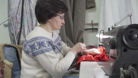 Female master tailor in making preparations for the red dress Stock Footage 126938635