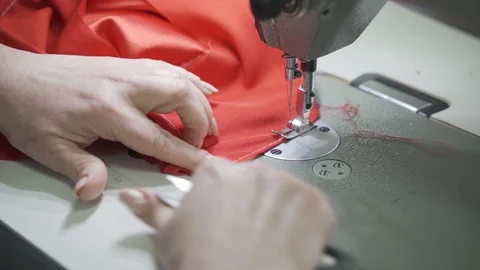 Female master tailor in making preparations for the red dress Stock Footage 126938671