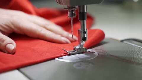 Female master tailor in making preparations for the red dress Stock Footage 126940206