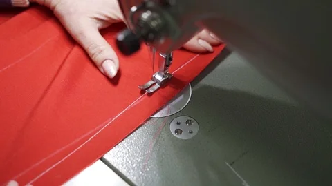 Female master tailor in making preparations for the red dress Stock Footage 126940255