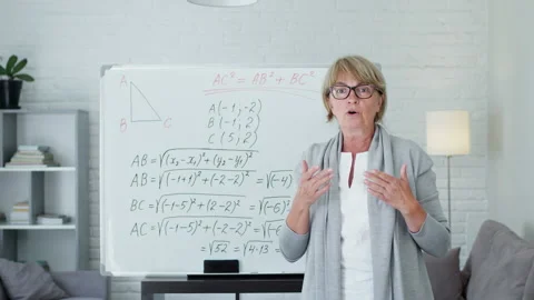 Female Math Teacher Explains Lesson At The Board. She Conducts Online Training Stockbeeldmateriaal 140864970